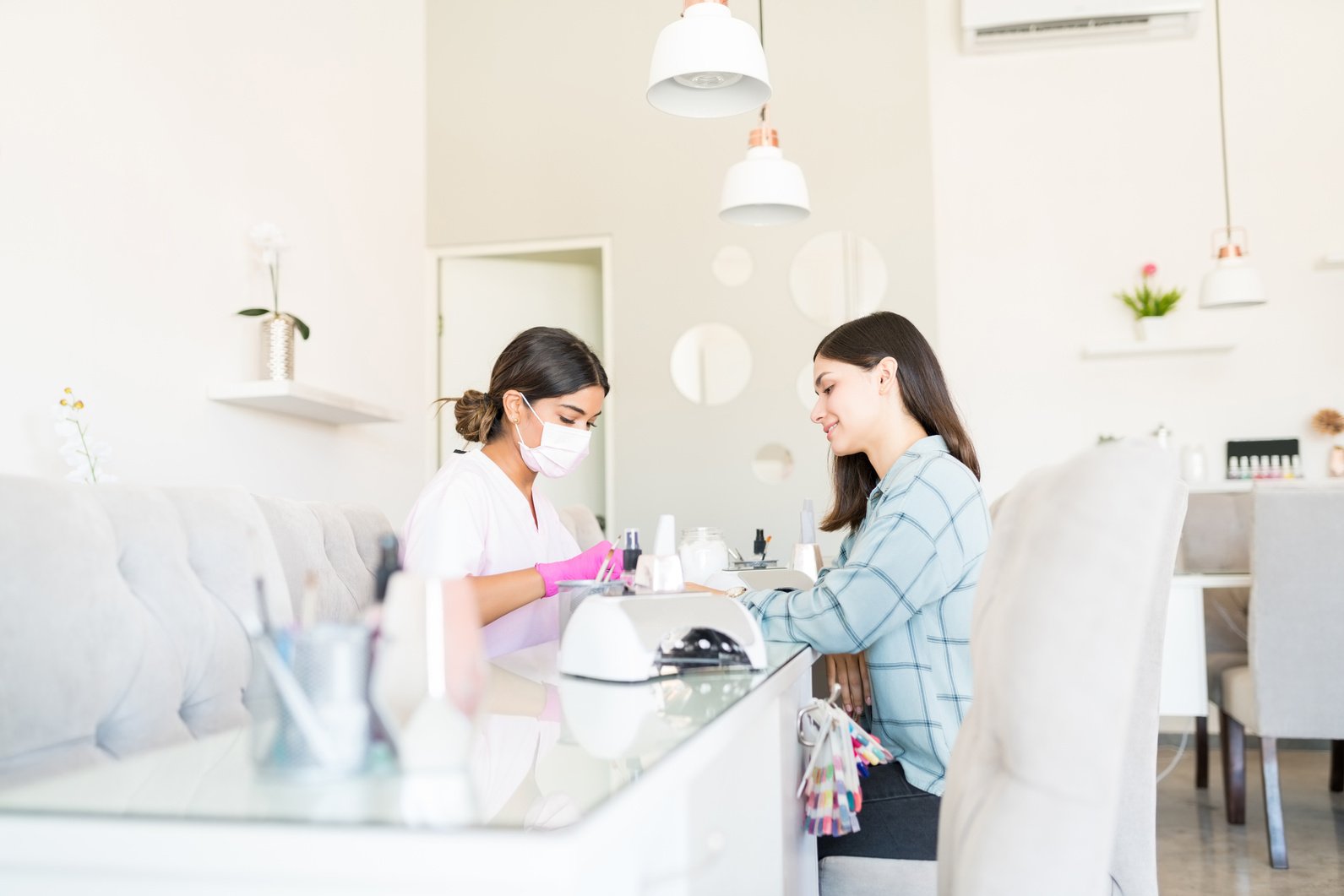 Manicurist And Customer In A Nail Salon.